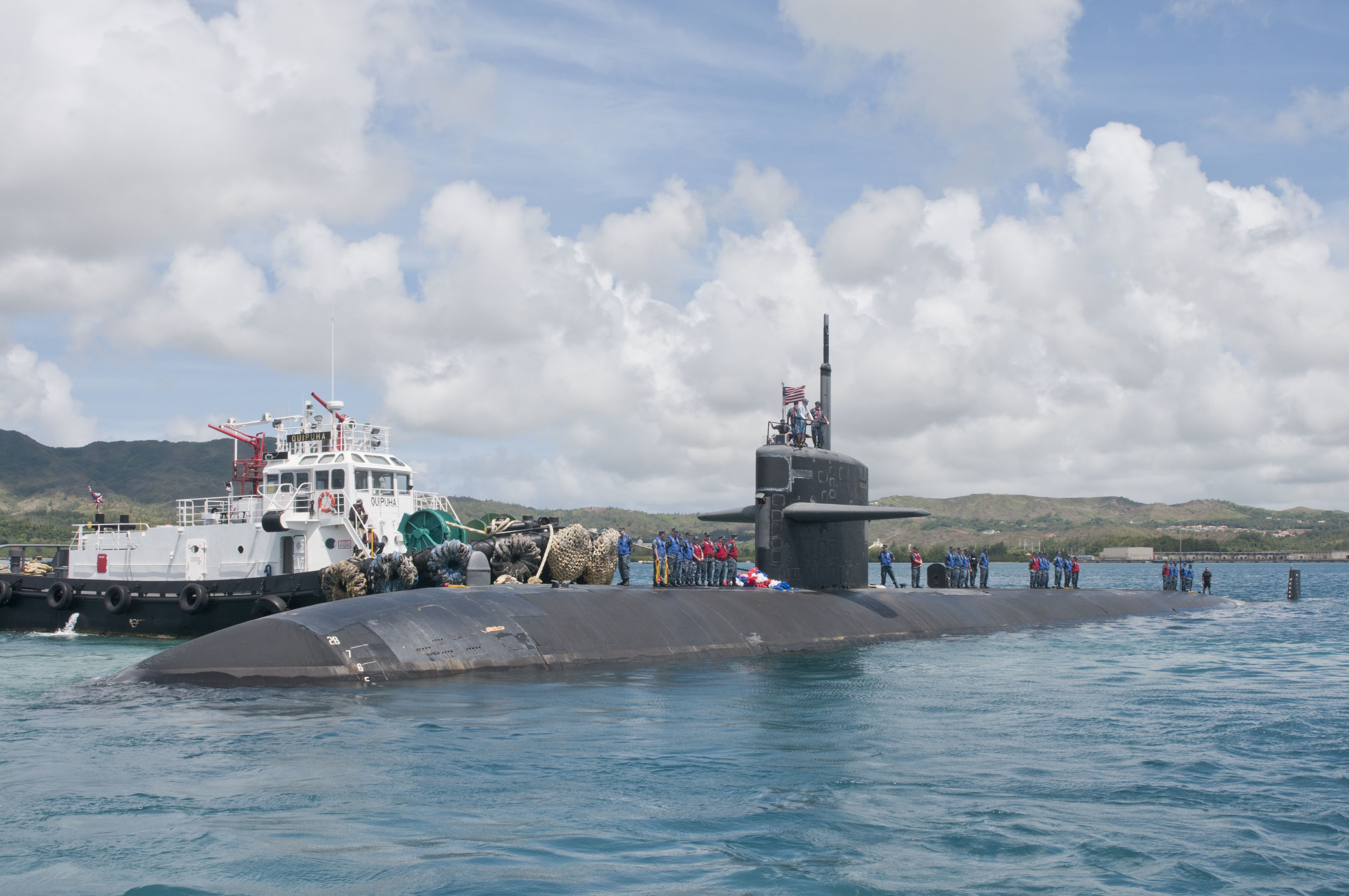 This is an image of a surfaced United States Navy submarine at Polaris Point, Guam.